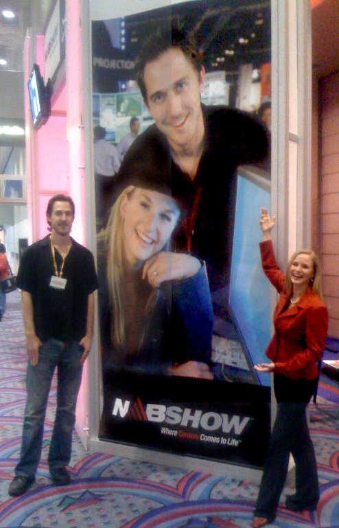 NAB - Chris and Jenn standing on each side of billboard